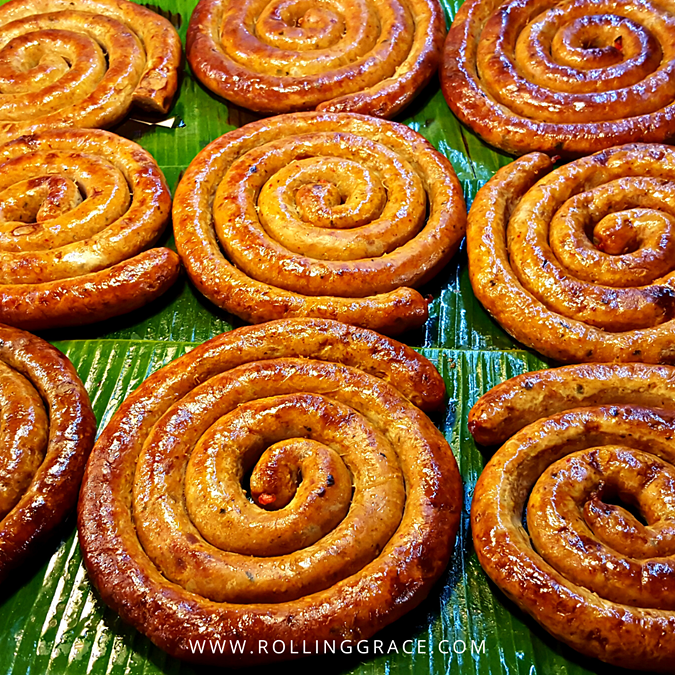 Coiled sai oua, northern Thai grilled pork sausages stuffed with lemongrass, galangal, and kaffir lime at a Chiang Mai market