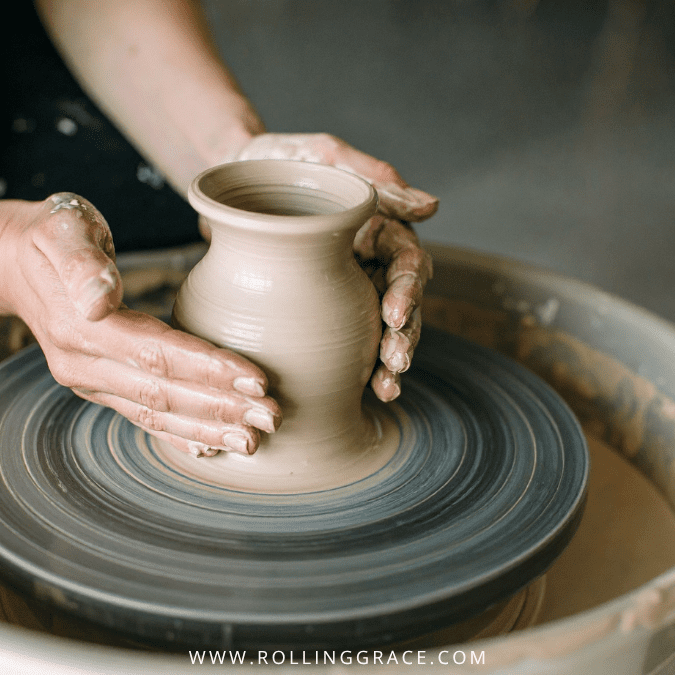 Potter's hands shaping clay on a wheel, representing Sarawak's earthenware craft tradition