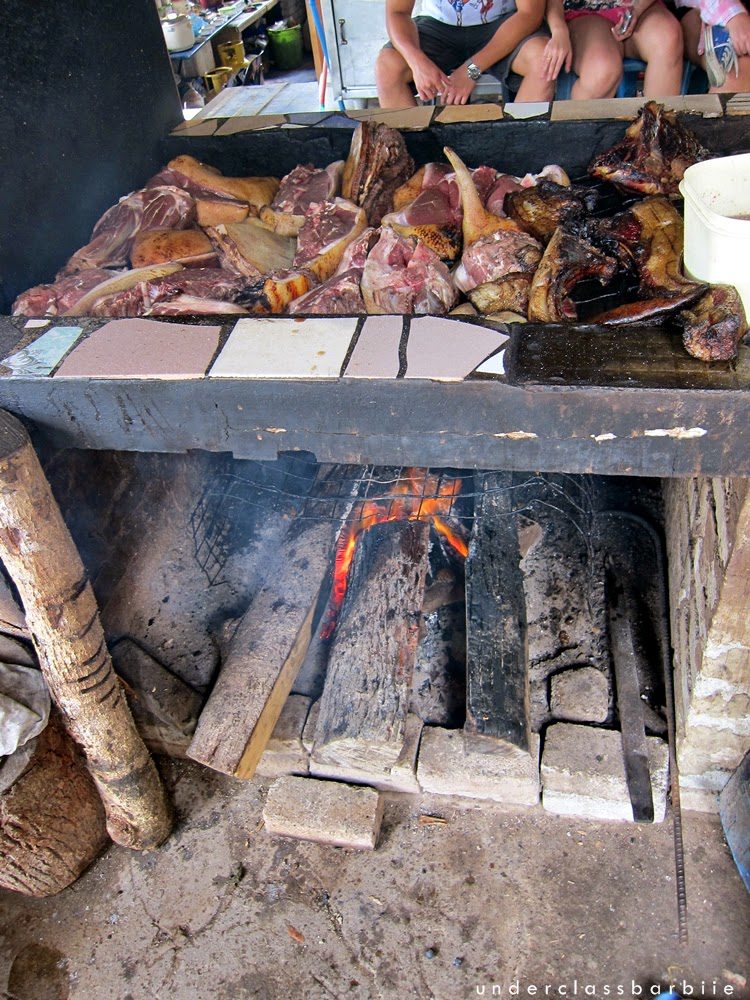 Wild boar meat smoking over open fire on a traditional grill, Sabah Malaysia