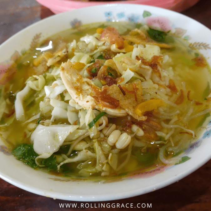 Bowl of soto with turmeric chicken broth, rice noodles, and a begedil at Warung Soto Pasir Penambang in Kuala Selangor