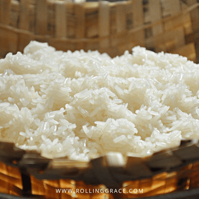 Cooked sticky rice served in a traditional woven bamboo kratip basket used across Thailand and Laos