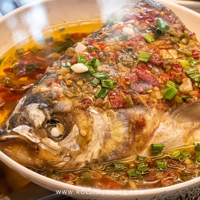 Bowl of spicy fish head soup with tomatoes and herbs at Sun Two Restaurant Kota Bharu Kelantan