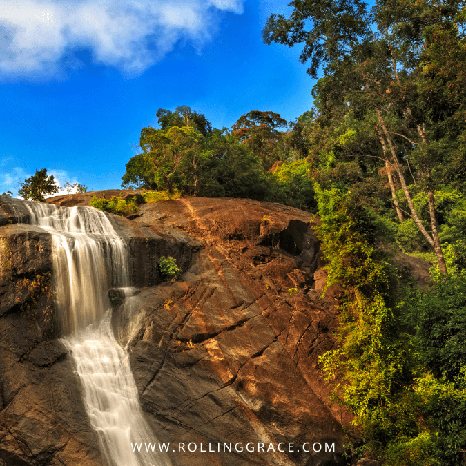 Cascading waterfall over red-brown rocks at Telaga Tujuh, Langkawi, Malaysia