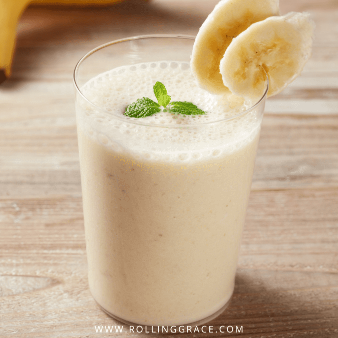 Creamy vegan peanut butter and banana smoothie in a glass with fresh mint garnish