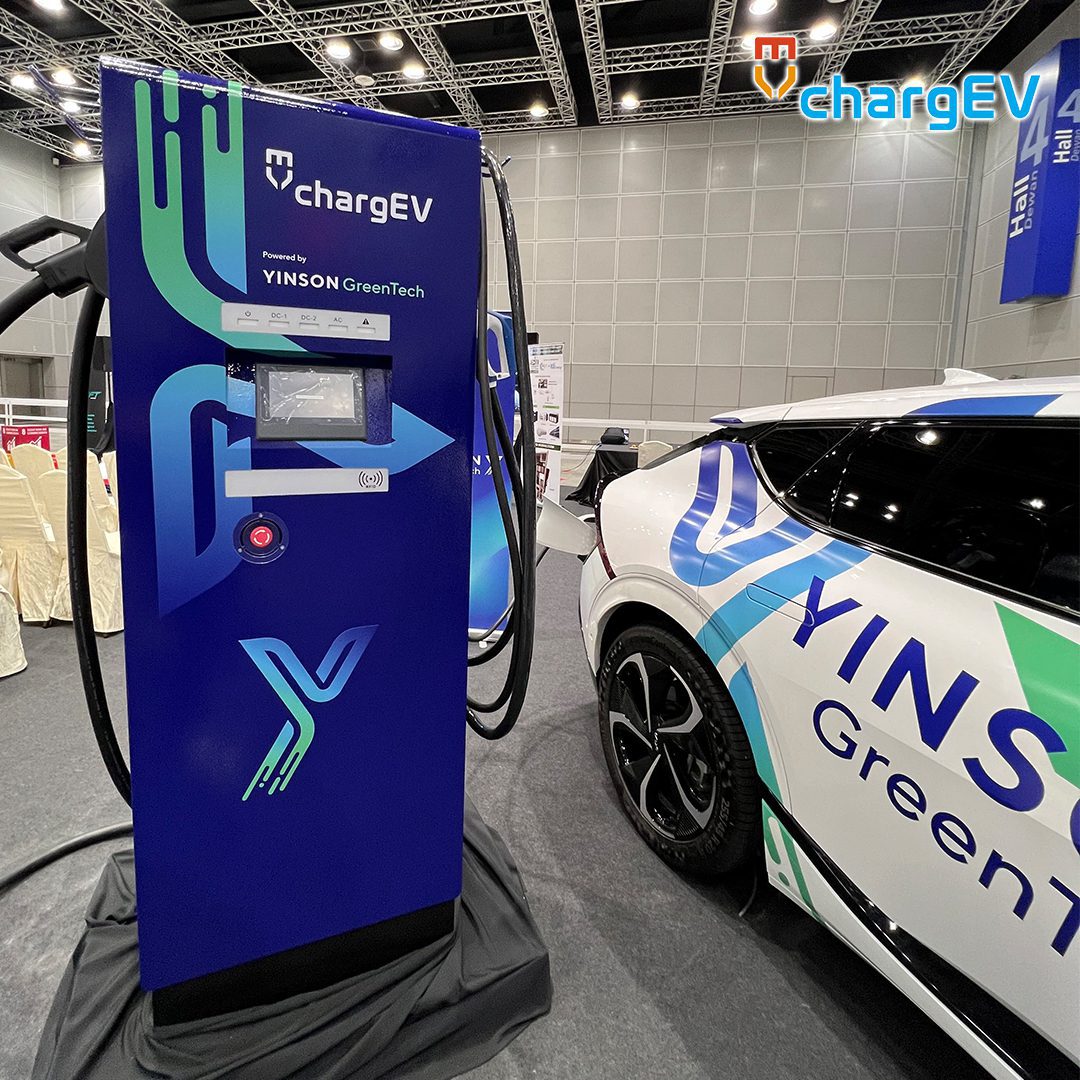 Best EV Chargers in Malaysia: 4 Most Reliable Networks 5 chargEV DC fast charger unit branded with Yinson GreenTech logo alongside a white electric vehicle in Malaysia.