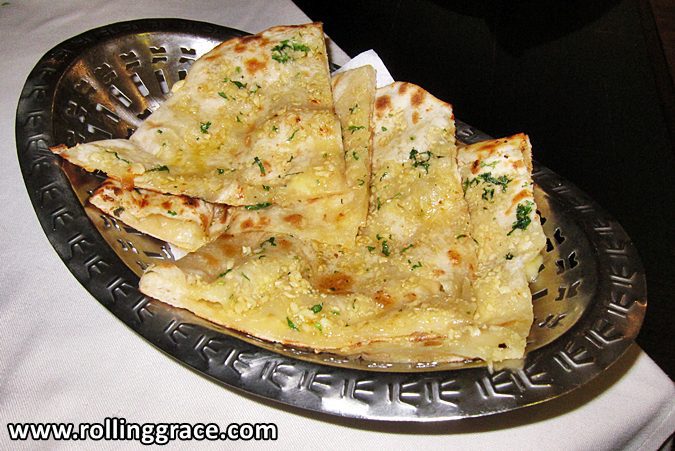 Crispy garlic naan baked in a charcoal tandoor oven served on a plate at Tandoor Grill Ipoh, Greentown, Perak.