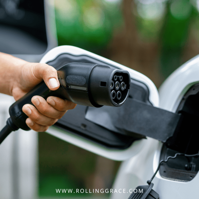 Best EV Chargers in Malaysia: 4 Most Reliable Networks 3 Hand holding a CCS2 EV charging connector at a public charging station in Malaysia.