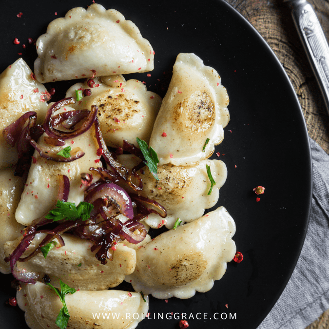 20 Best Dumplings in the World You Need to Try at Least Once 9 Fried Polish pierogi dumplings in butter with caramelised onion on a plate.