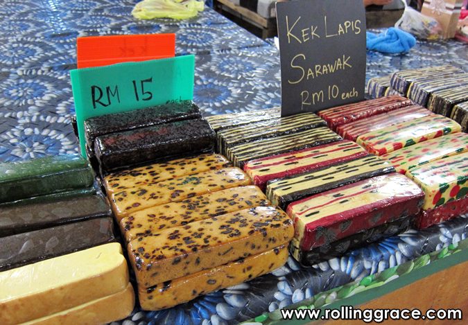 Best Sarawak Food: 20 Must-Try Traditional Dishes Guide 5 Kek Lapis Sarawak colourful layered cake squares for sale at a Kuching market stall