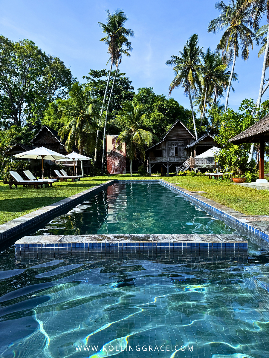 Aerial view of swimming pool flanked by heritage villas and tropical garden at Bon Ton Resort, Langkawi, Malaysia