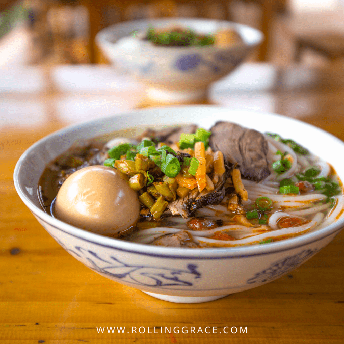 Bowl of Guilin Rice Noodles with beef brisket and braised egg in a porcelain bowl