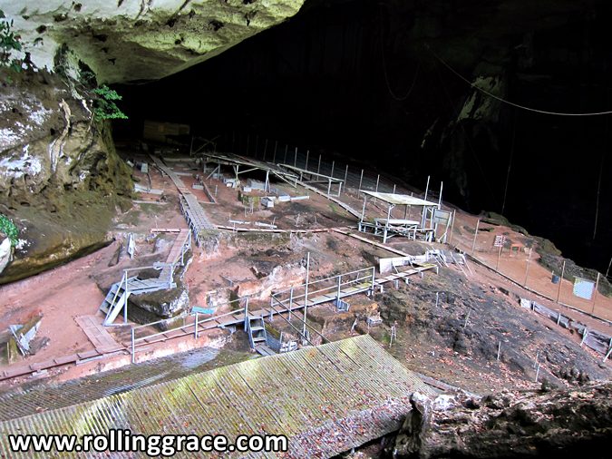 Fenced archaeological excavation site with walkways inside the Niah Great Cave, Sarawak