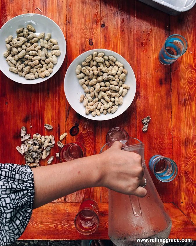 Ladang Nira Nipah Napiah: 6 Best Things to Do in Merbok 3 Hands tapping fresh air nira from a nipa palm stalk into bottles at Ladang Nira Nipah Napiah Kedah