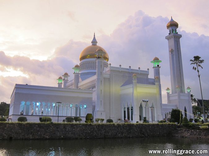 Best Mosques in Brunei: 6 Most Beautiful Must-Visit Places 5 Masjid Omar Ali Saifuddien gold dome and lagoon in Bandar Seri Begawan Brunei at dusk