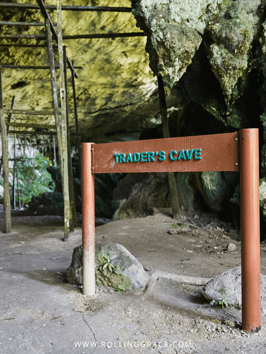 Wooden Trader's Cave signboard beneath the limestone rock shelter at Niah National Park, Sarawak