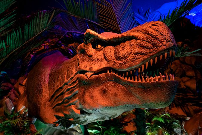 Orange LED-illuminated giant insect animatronic from Insectopia zone at Wetland Studios Putrajaya featuring prehistoric insects and interactive nature exhibits