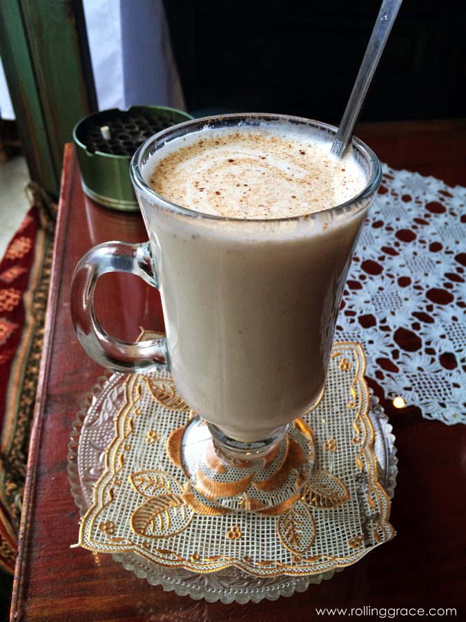 Čajdžinica Džirlo: A Beautiful Sarajevo Tea House in Bosnia 4 Tall glass of milky salep topped with cinnamon on a lace doily at Čajdžinica Džirlo Sarajevo