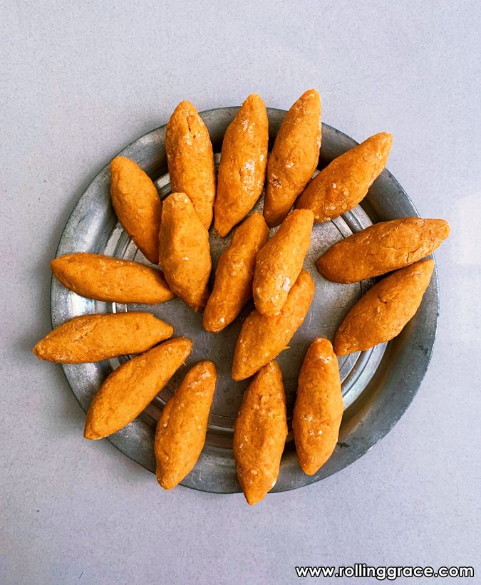 Golden crispy Cek Mek Molek sweet potato snacks arranged on a metal plate