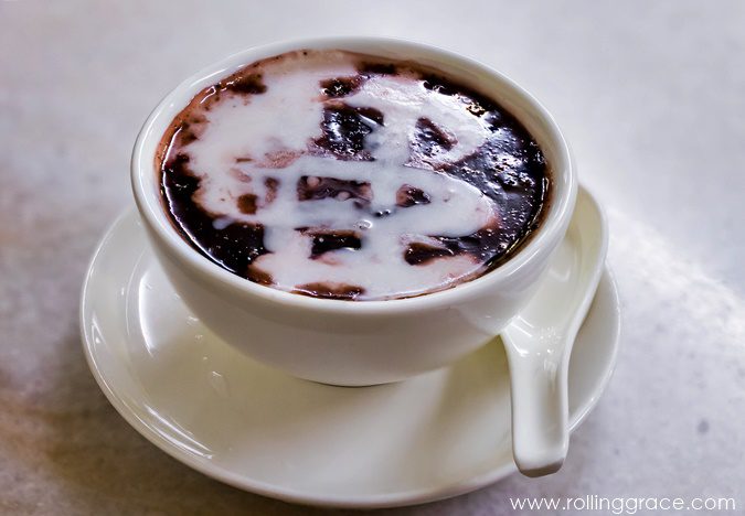 Bubur pulut hitam black glutinous rice porridge with coconut milk in a cup, a sweet Malaysian rice dish