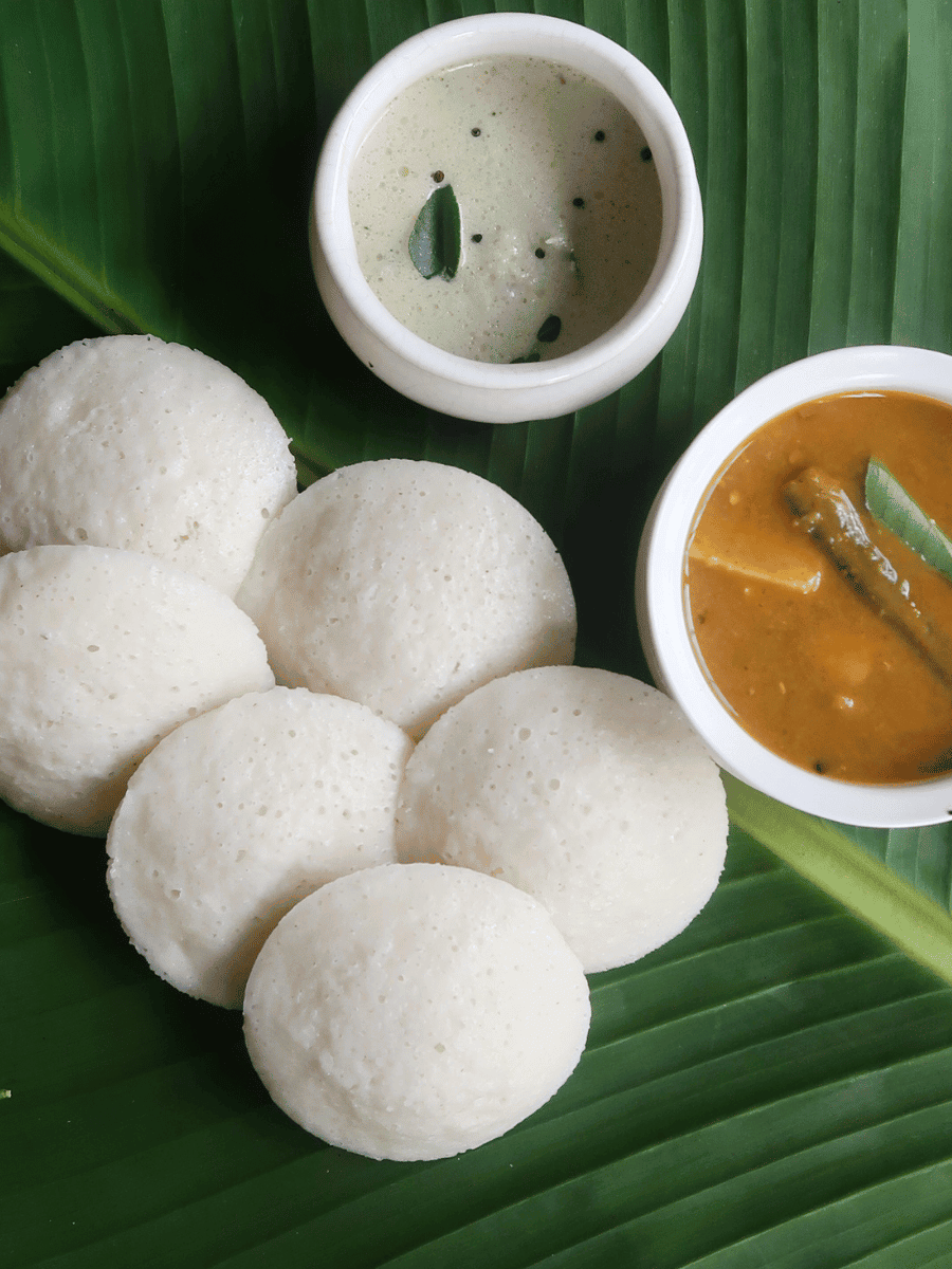 Idli South Indian steamed rice cakes served with sambar and coconut chutney, a breakfast Malaysian rice dish