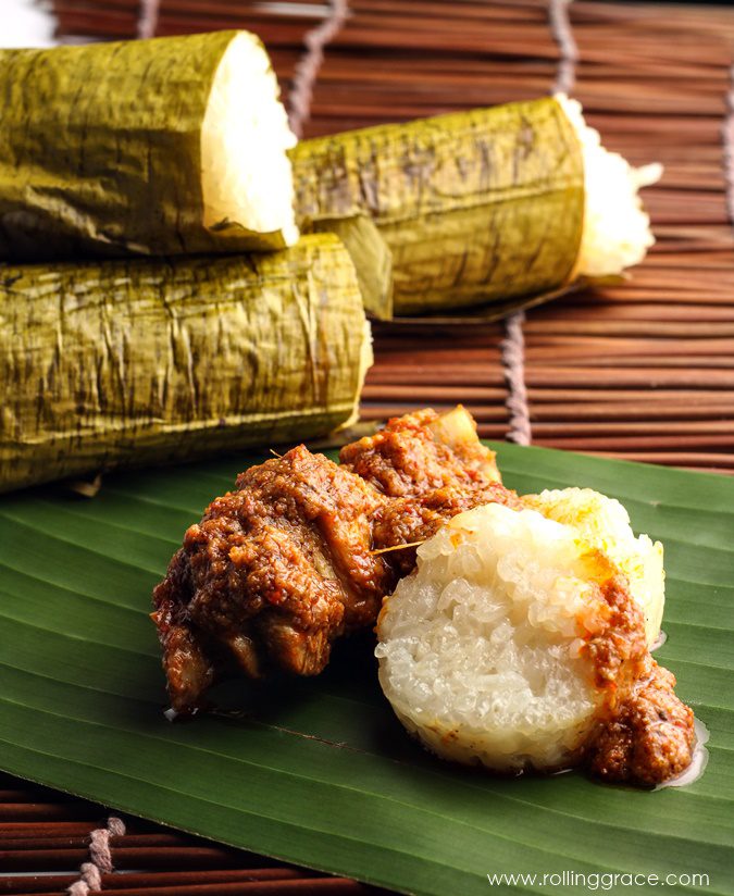 Lemang glutinous rice roasted in bamboo poles lined with banana leaves served with rendang, a festive Malay Malaysian rice dish