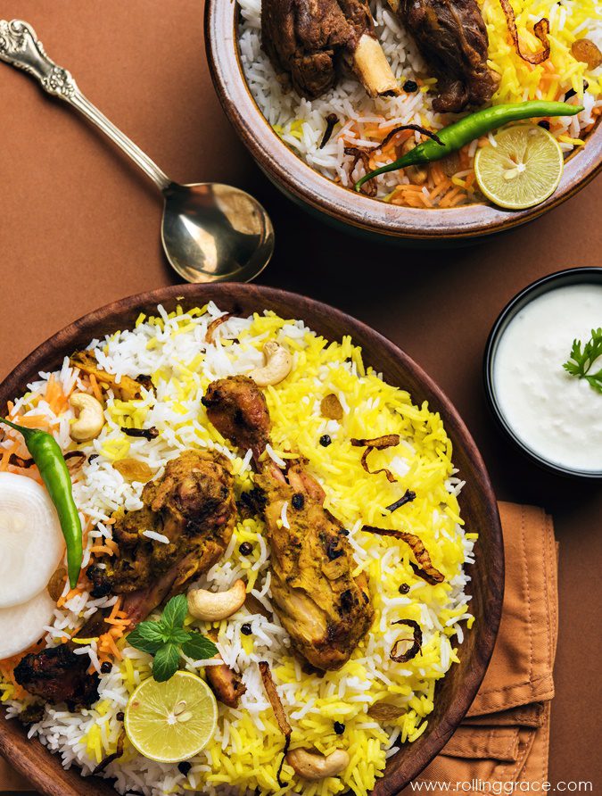 Nasi biryani with saffron basmati rice and spiced meat served with accompaniments, a festive Indian Malaysian rice dish