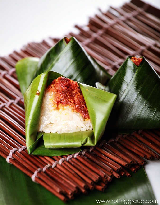 Pulut inti Peranakan dessert of blue glutinous rice with sweet grated coconut wrapped in banana leaf, a Nyonya Malaysian rice dish