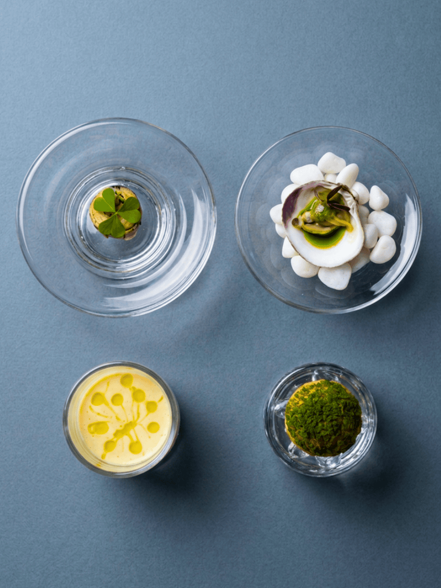 Four delicate amuse bouches served in small glass vessels at Ortensia Shanghai