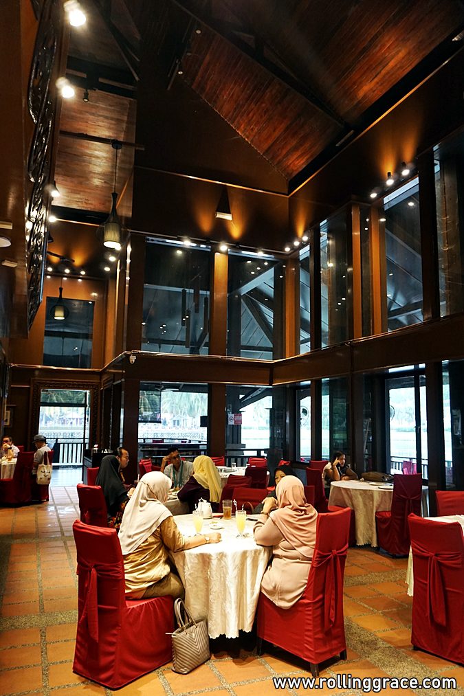 Diners in the wooden-beamed interior hall of Putrajaya Seafood Restaurant in Putrajaya