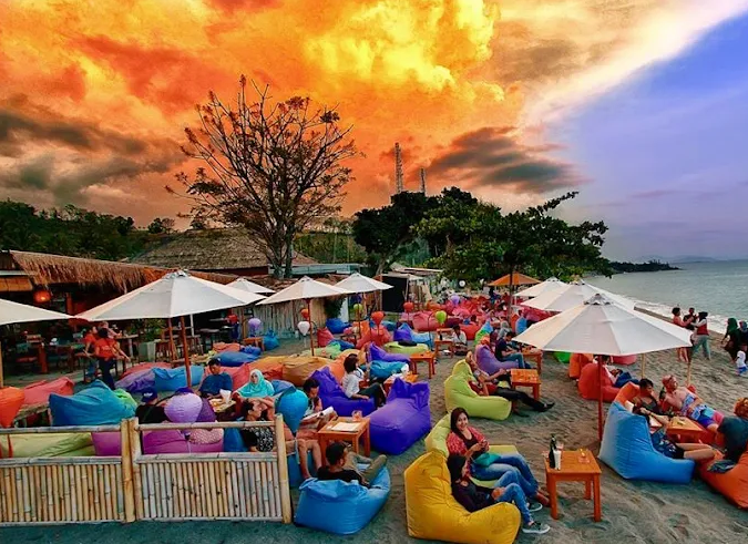 8 Best Shisha in Lombok for a Stunning Sunset Session 5 Colourful beanbags on a black-sand beach at sunset at La Chill Bar in Senggigi Lombok