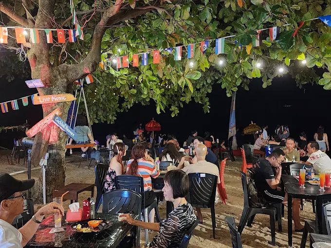 10 Best Shisha in Penang: Exciting Island Hookah Experience 11 Beachfront tables under festoon lights at Laguna Bay Beach Bar in Tanjung Bunga Penang