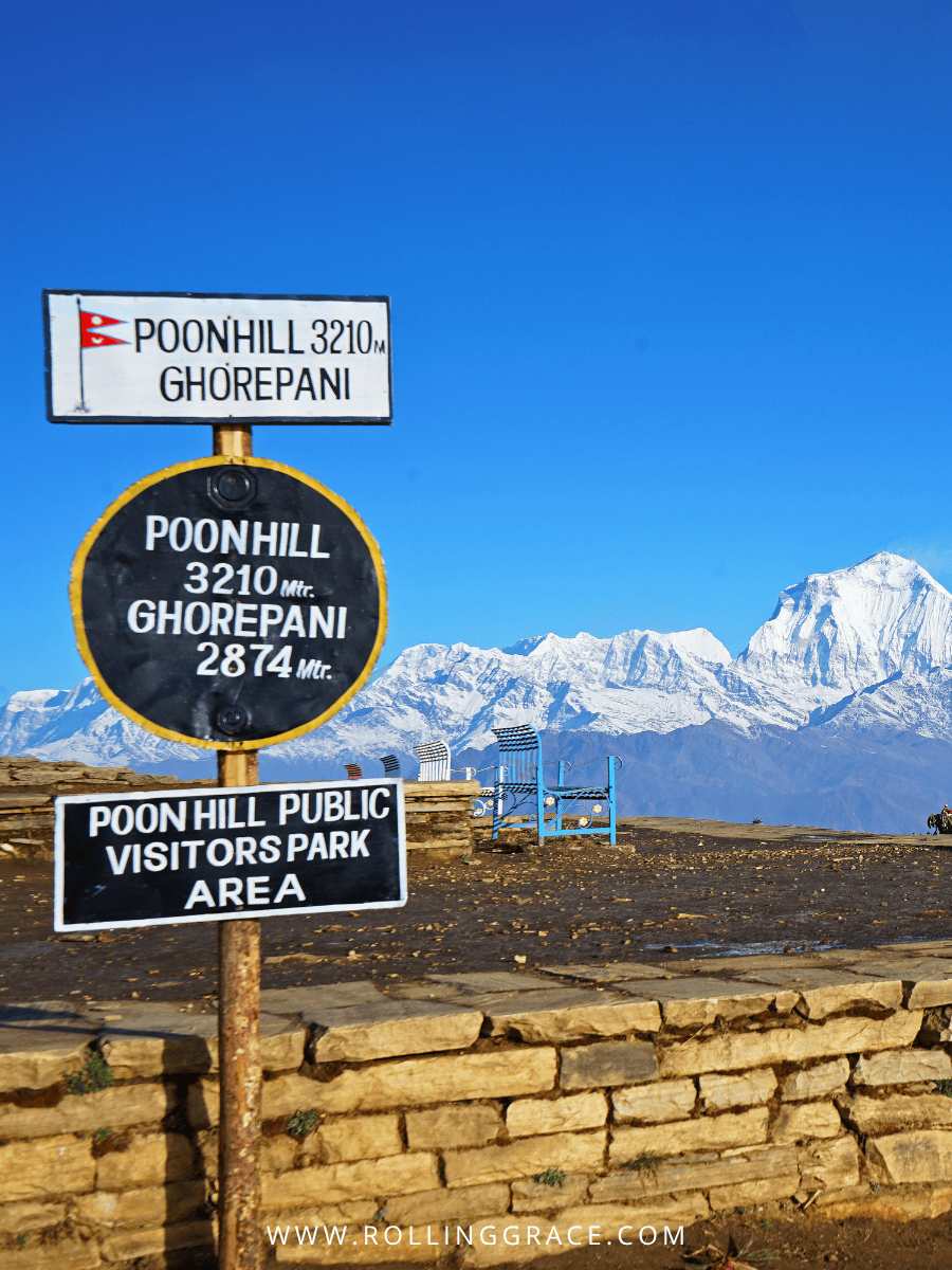 Poon Hill Ghorepani trail signpost with snow peaks behind in Nepal