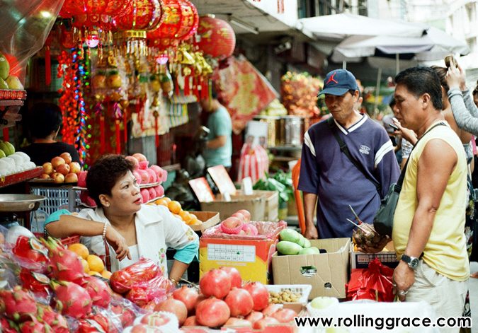 Shoppers browsing fruit and goods at Gaya Street Sunday Market in Kota Kinabalu Sabah