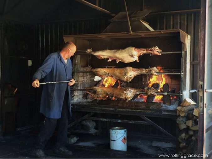 Whole lamb roasting on a spit over open flame in Bosnia