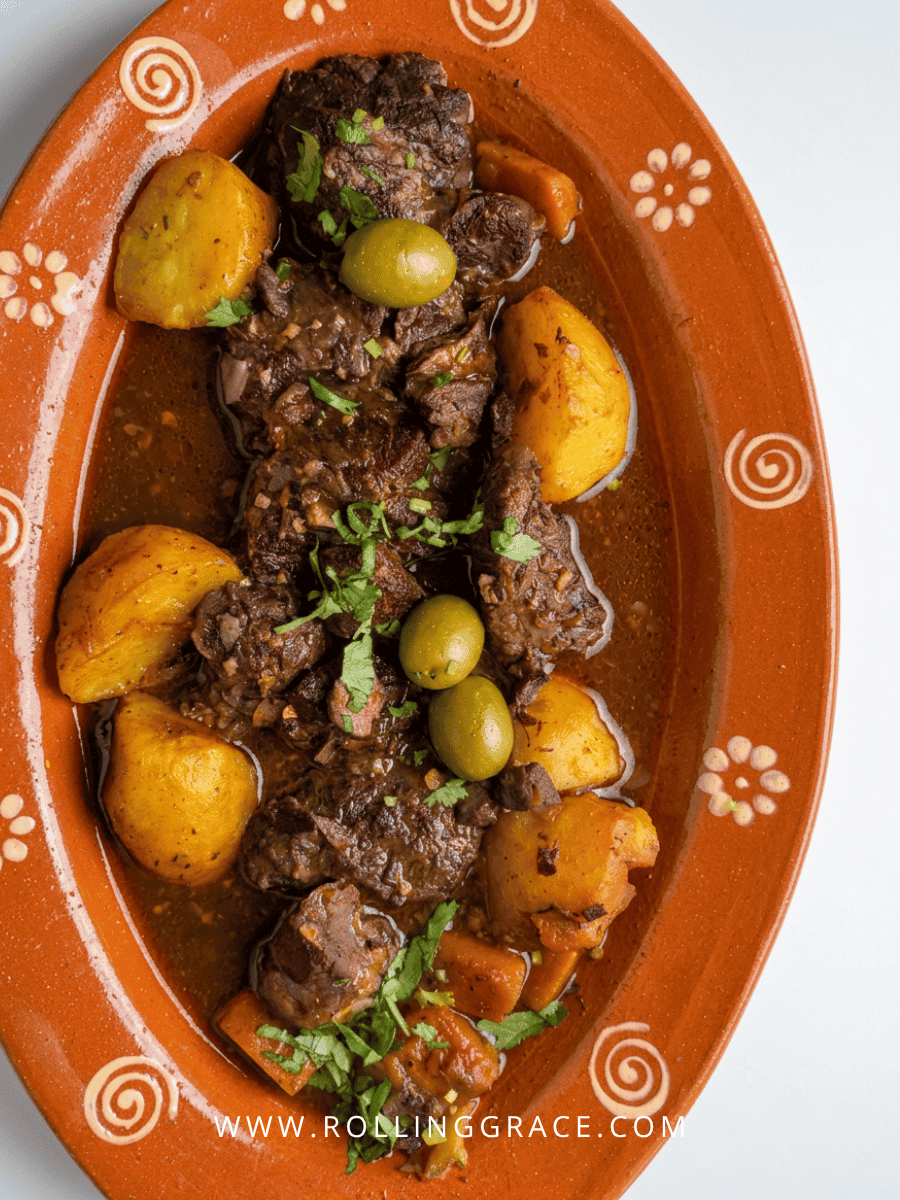 Amália Portuguese Restaurant Macau: 7 Best Dishes to Try 16 Slow-cooked Iberian pork cheeks in wine sauce on an orange clay plate at Amália Portuguese Restaurant Macau
