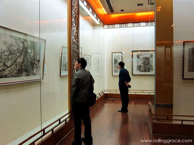 7 Stunning Things to See at Du Fu Thatched Cottage Chengdu 18 Visitors viewing artwork and calligraphy in an exhibition gallery at Du Fu Thatched Cottage Chengdu