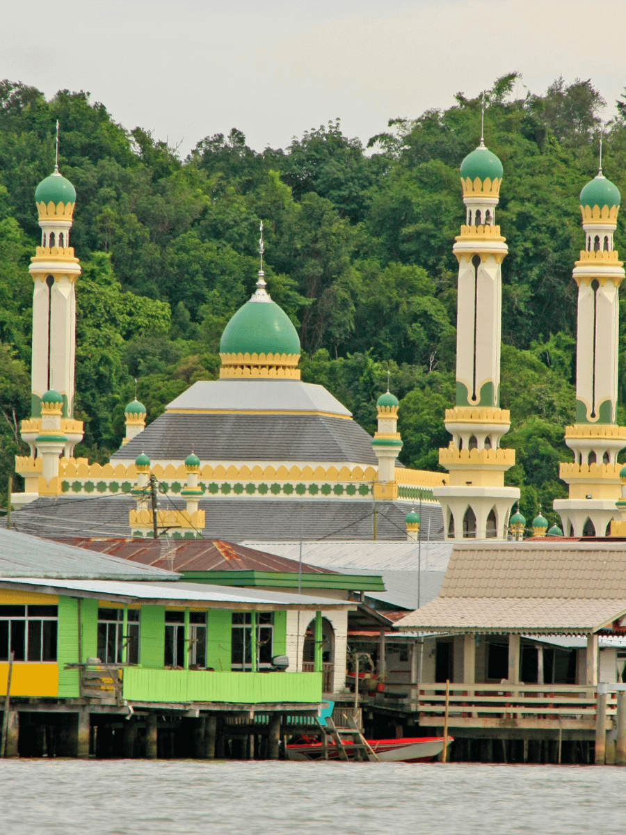 7 Best Things to Do at Kampong Ayer Brunei Water Village 4 Mosque with gold dome and minarets built on stilts alongside colourful houses at Kampong Ayer Brunei