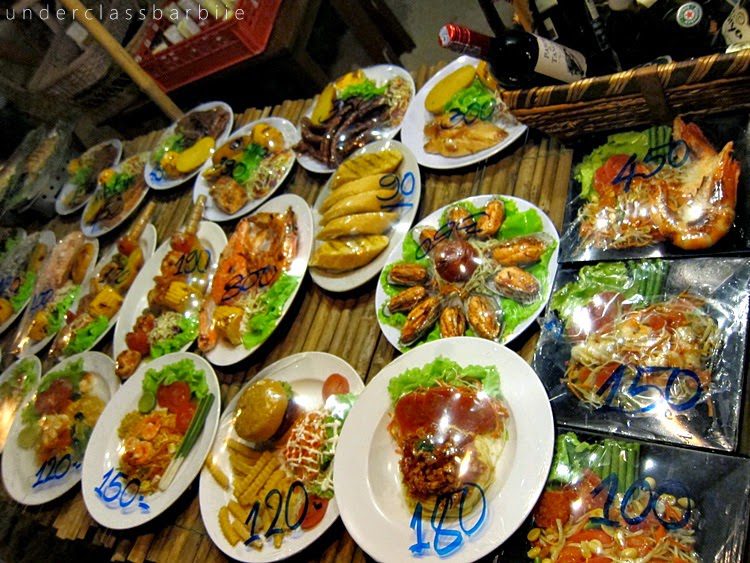 Koh Samet Thailand: 8 Best Relaxing Things to Do 9 Large spread of fresh Thai seafood dishes served beachside at Koh Samet Thailand