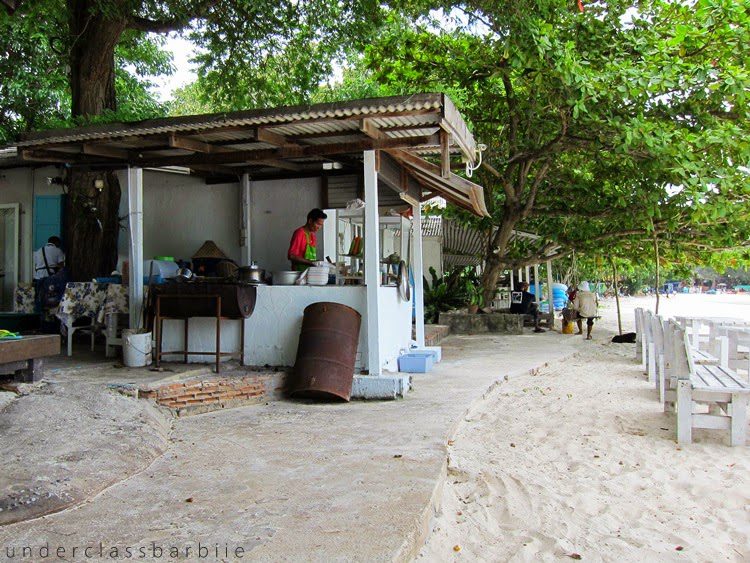 Koh Samet Thailand: 8 Best Relaxing Things to Do 14 Small beachfront restaurant shack with white furniture and shade on the sand at Koh Samet Thailand