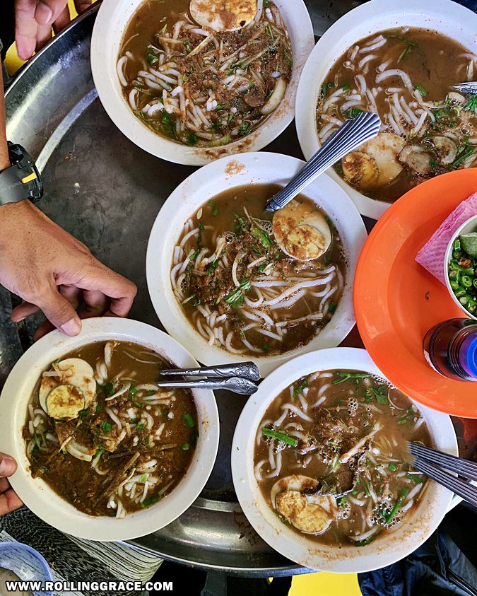 Overhead view of a spread of local northern Malaysian dishes on the table at Ladang Nipah Kipli Perlis
