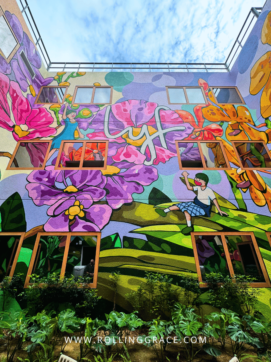 Colourful floral mural in an outdoor courtyard at lyf Chinatown Singapore