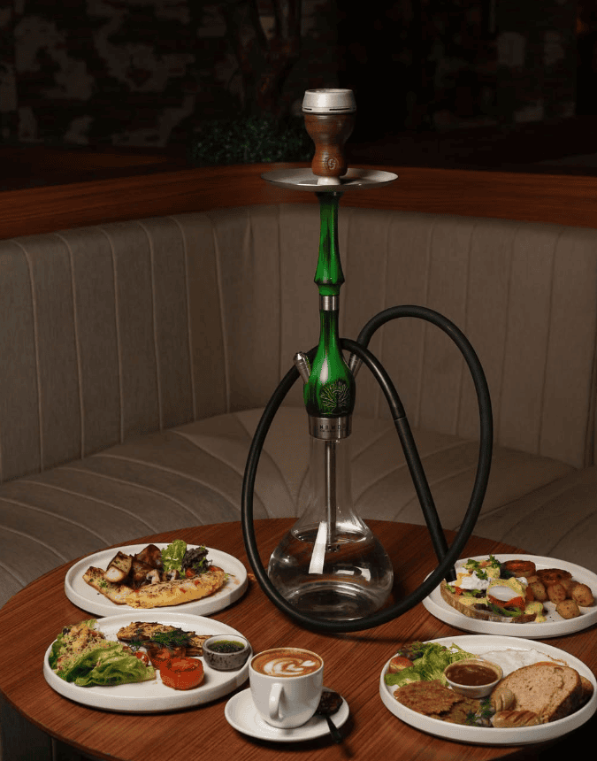 12 Best Shisha in Bali: Hookah in Canggu, Seminyak & Ubud 3 Outdoor terrace at Eden Hookah Club Seminyak with food, hookah and lounge seating, featured in Rolling Grace best shisha in Bali guide