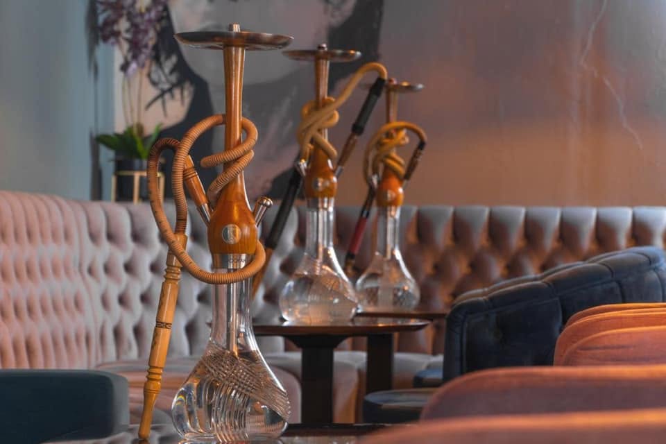 Adara Lounge Friedrichshain Berlin with plush seating and hookah pipe in a modern lounge interior