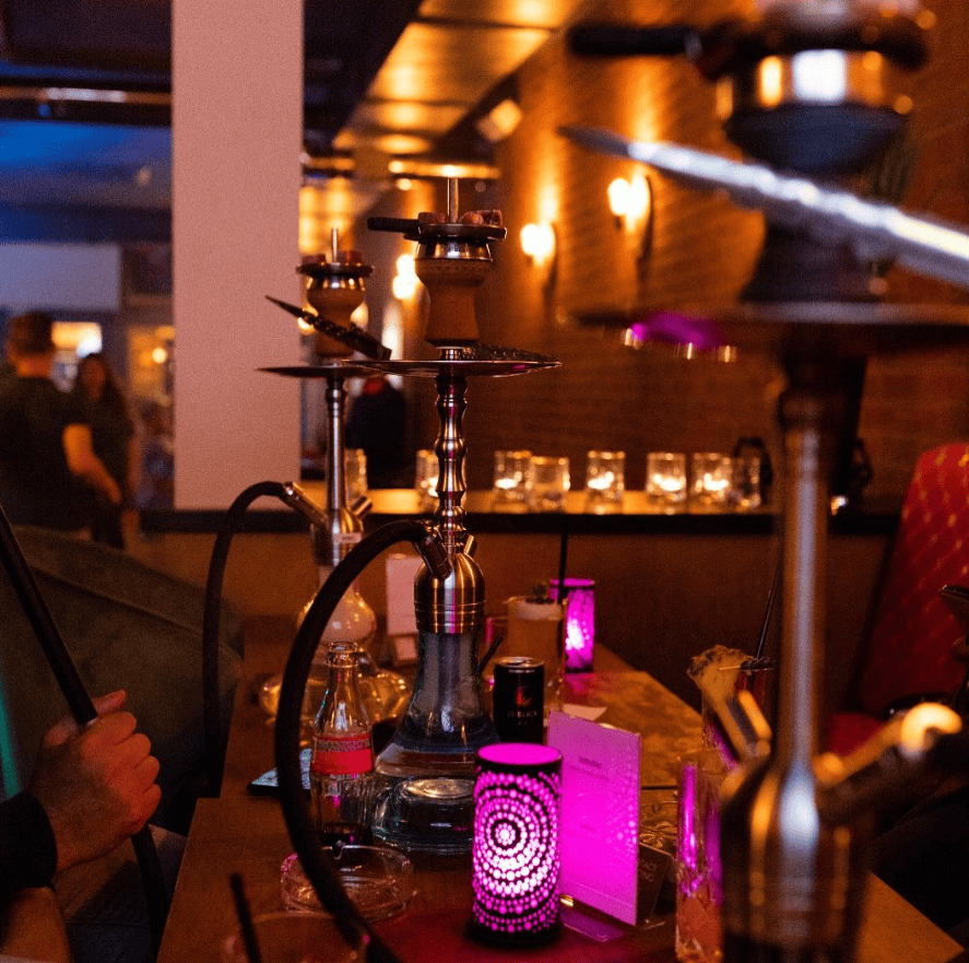 Marrakesch Lounge and Bar Berlin with ornate hookah pipe and Moroccan-inspired pink and gold interior