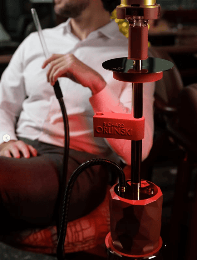 HuQQa Dubai Mall premium red hookah pipe with staff preparing shisha at the table