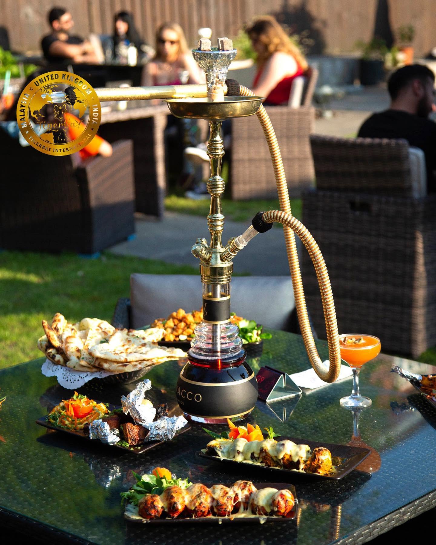 TigerBay Shisha Lounge Kingsbury hookah pipes and food platters in a vibrant lounge setting