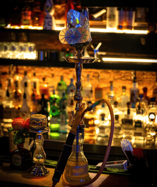 Karizma Midtown East hookah lounge bar area with neon lighting and cocktail service