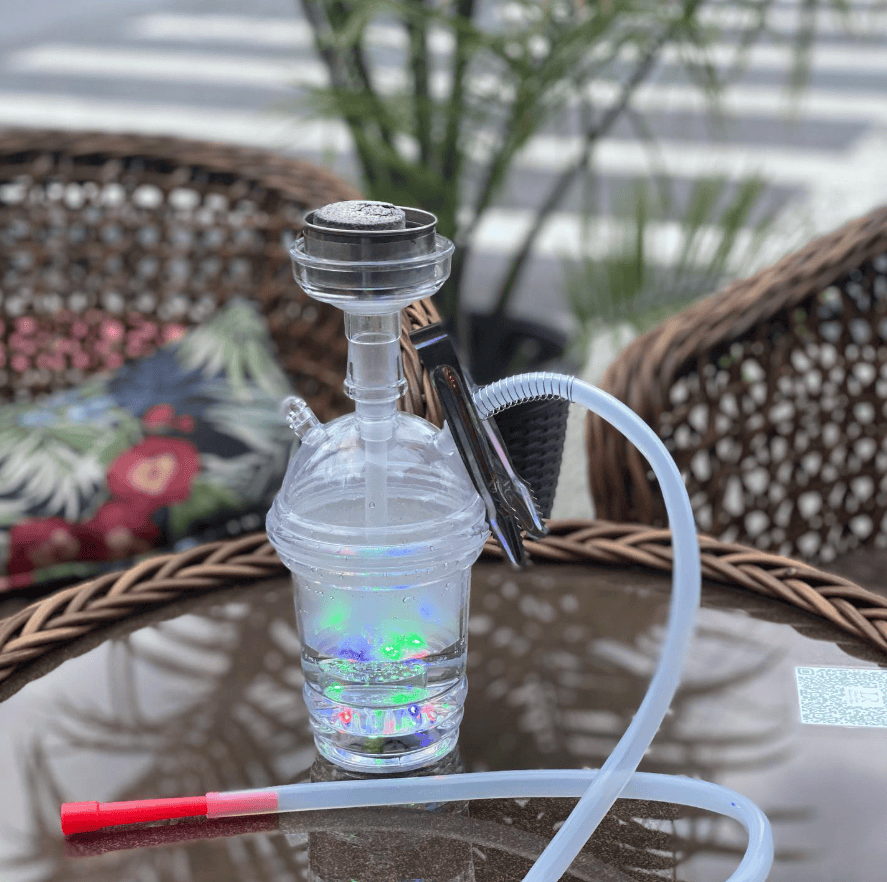 Living Room Restaurant and Lounge Brooklyn hookah pipe on a wicker table at the Avenue U shisha spot