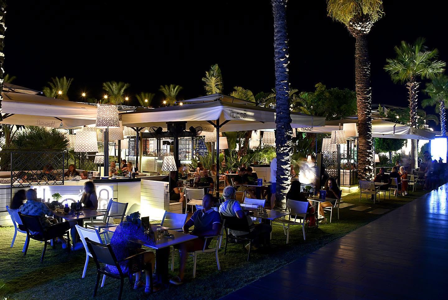 Best Shisha in Istanbul, Turkey: 10 Amazing Nargile to Try 6 Outdoor terrace seating with warm lighting at HuQQa Kuruçeşme overlooking the Bosphorus in Istanbul