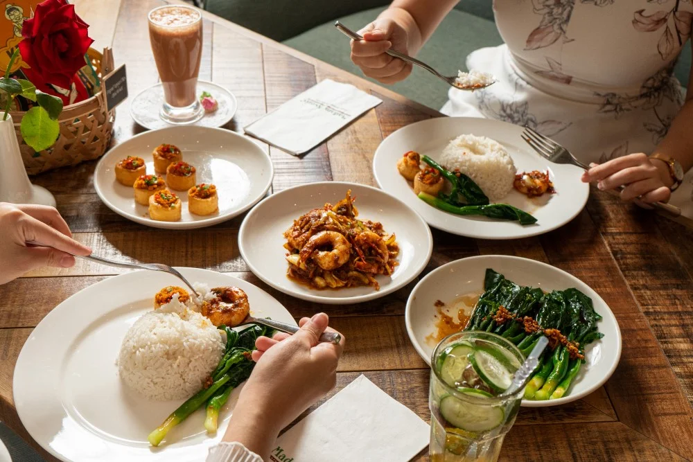 10 Best Halal Restaurants in TRX The Exchange Kuala Lumpur 6 Madam Kwan's TRX halal Malaysian dishes including nasi lemak and satay on a wooden table